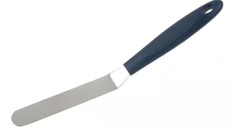 Angled spatula with navy blue handle against a white background