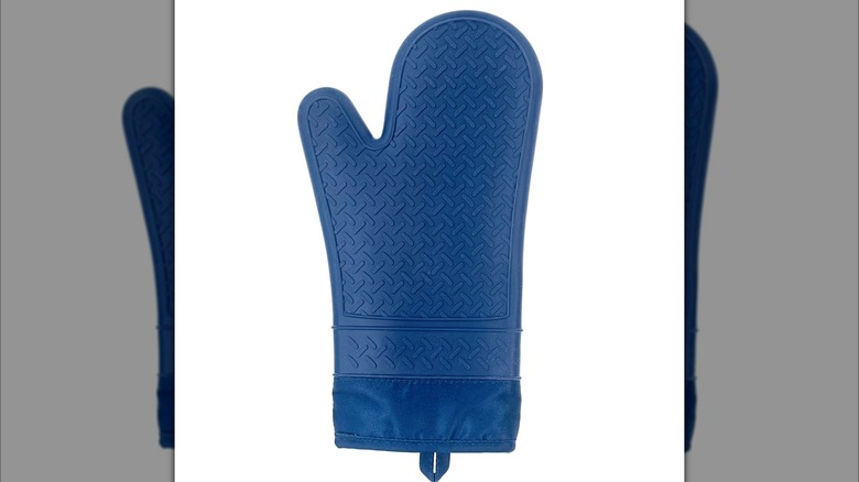 Blue silicone oven mitt against white background