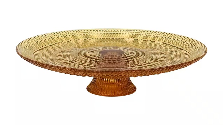 Brown clear glass cake stand against a white background.
