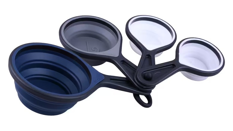 Silicone measuring cup set in blue, gray, white against a white background