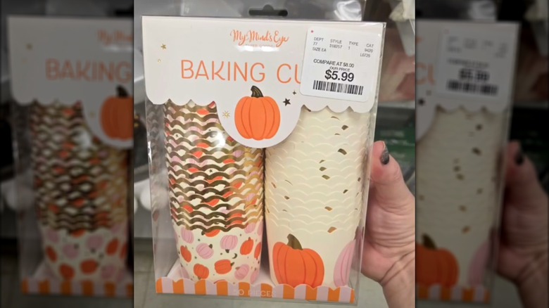 Hand holding up fall decorated baking cups