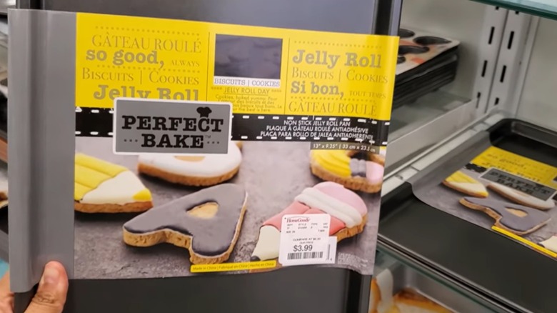 Hand holding a jellyroll pan in a HomeGoods