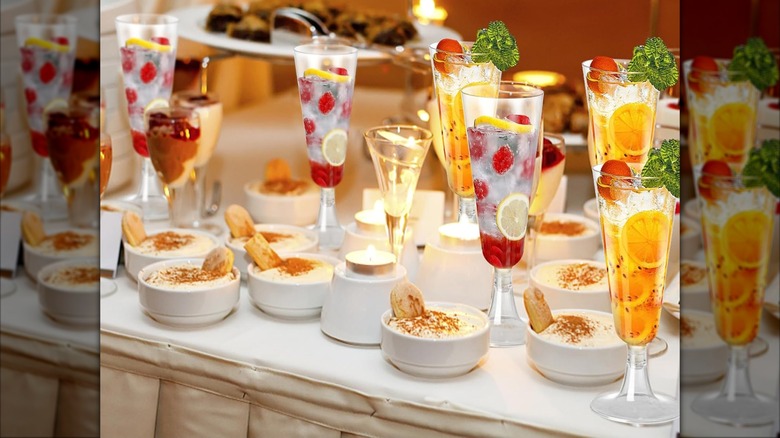 Product image of SUREHOME Plastic Champagne Flutes on a festive table with snack bowls