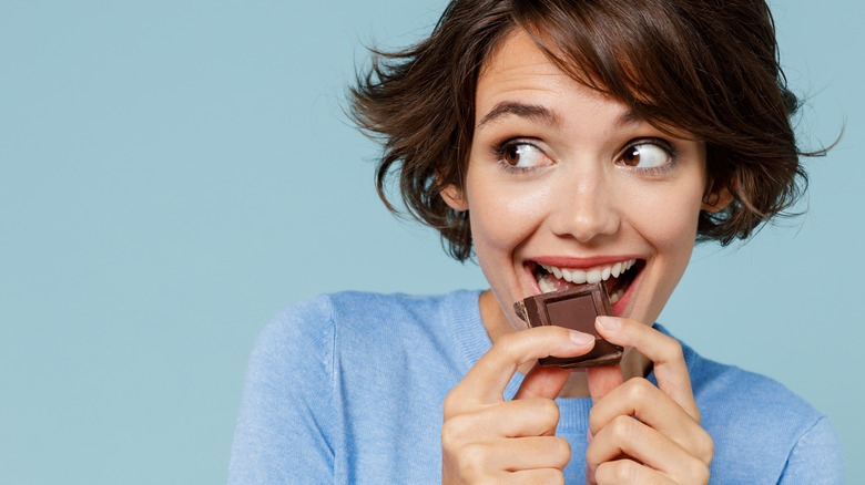 woman eating a chocolate bar