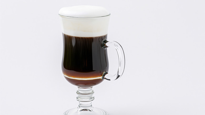 A mug of Irish coffee on white background