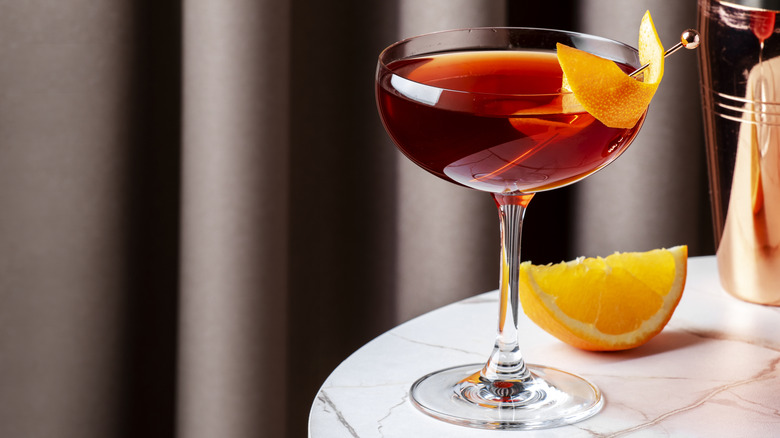 A glass of Revolver cocktail with orange peel