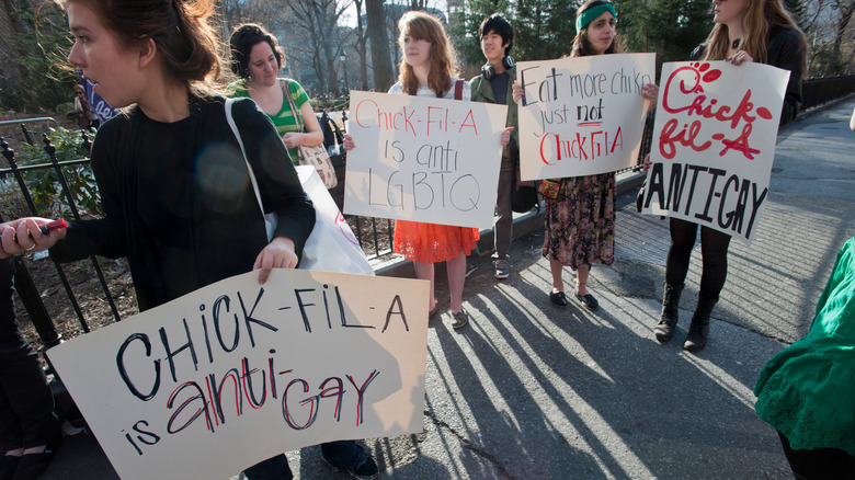 A group of people with signs that read "Chick-fil-A is anti-gay" during a protest outside Chick-fil-A