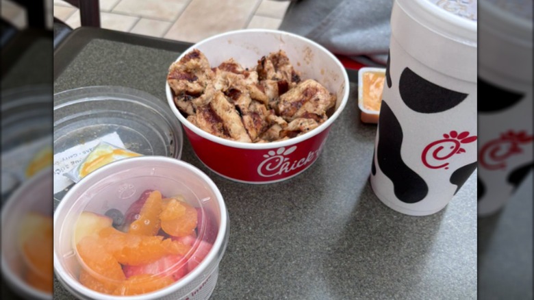 Chick-fil-A grilled chicken nuggets with a fruit cup and a drink