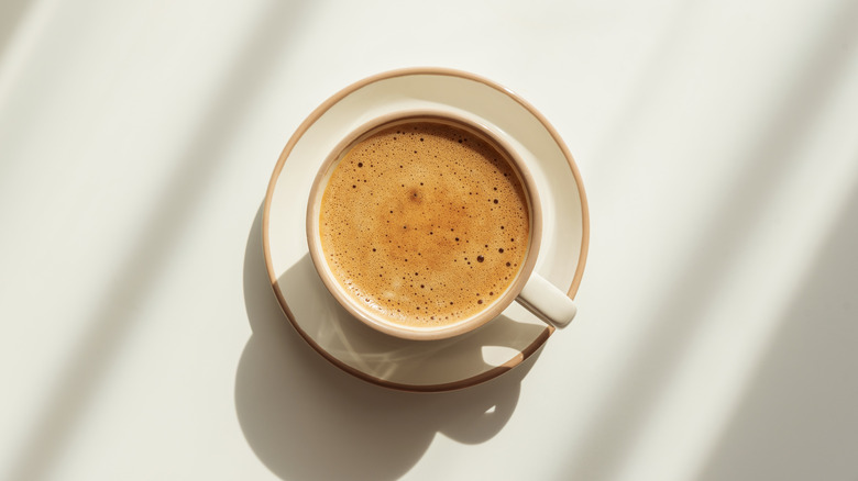 A cup of freshly brewed coffee, seen from above