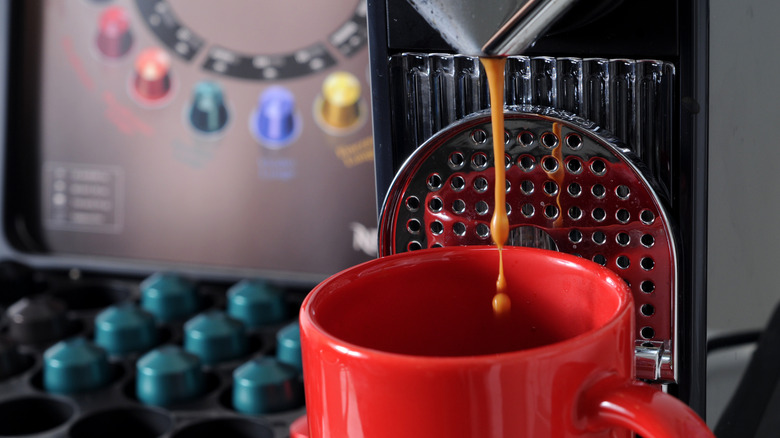 A Nespresso machine brews a cup of coffee