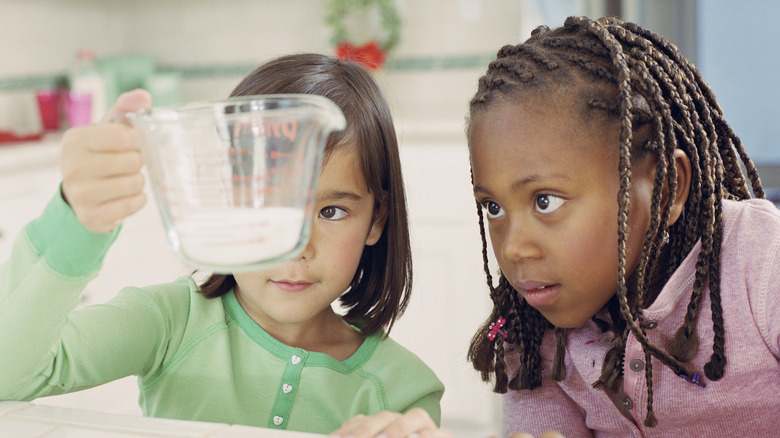 Kids measuring baking ingredients