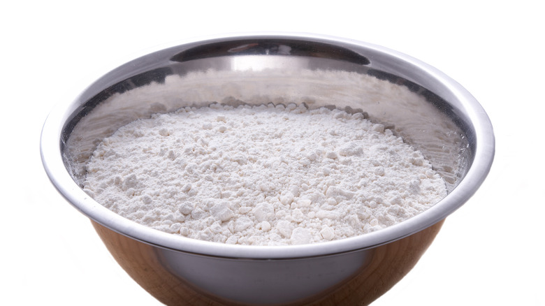 Lumpy flour in metal bowl