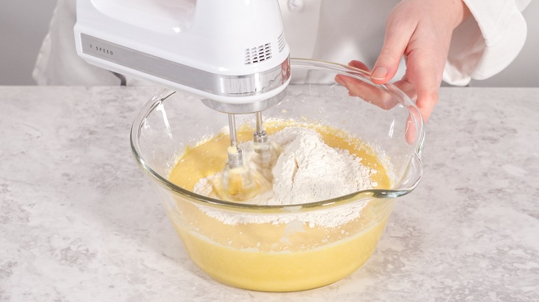 Mixing flour into cake batter