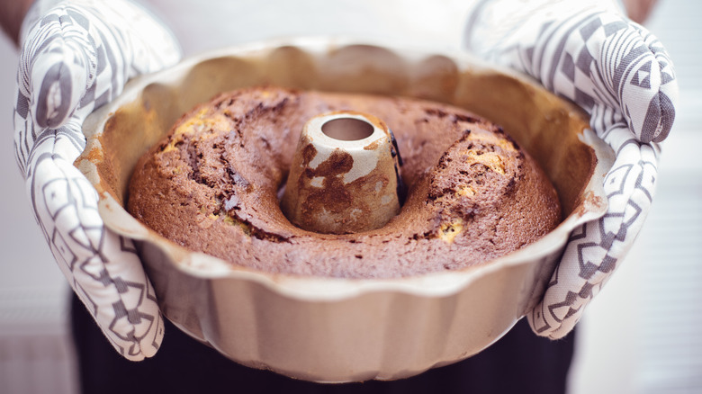 Person holding hot Bundt cake