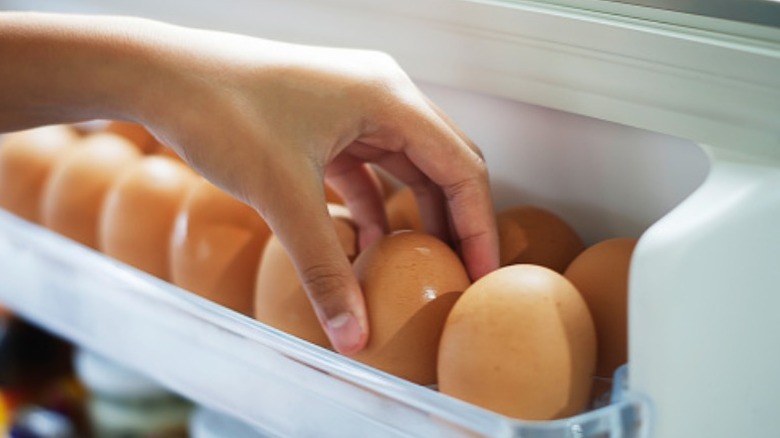 Grabbing egg out of fridge