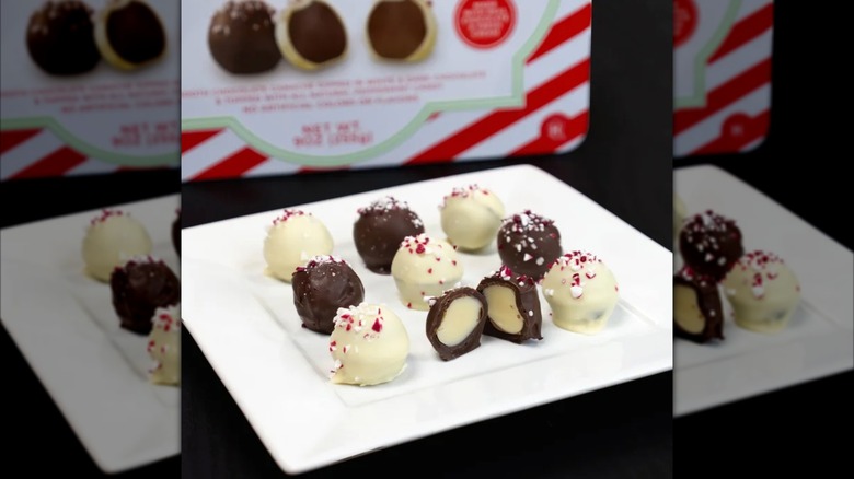 WHite and milk chocolate covered truffles topped with crushed peppermints