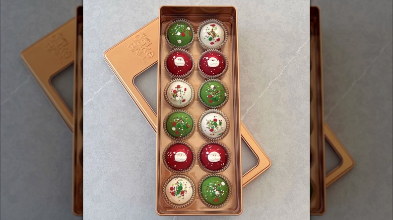 A gift set of 12 cake balls inn red, green, or white, in a copper-colored gift box