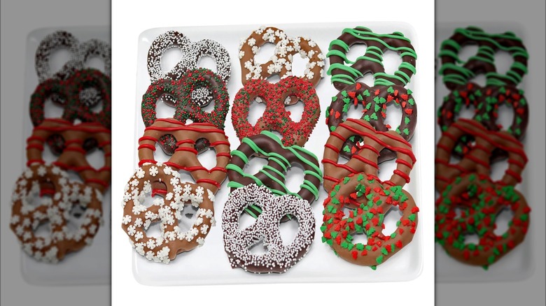 An assortment of 12 chocolate covered pretzels with various drizzles and sprinkles