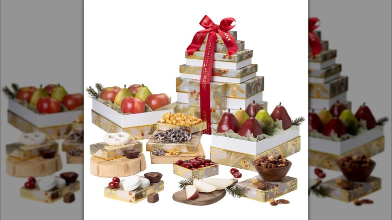 A tower of gold and white boxes wrapped with red ribbon; several more are opened revealing snacks inside