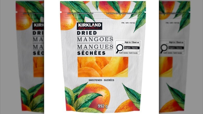 Sweetened dried mangoes on white background