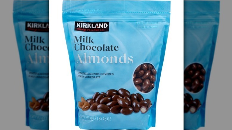 Milk chocolate almonds on white background