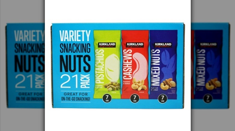 Variety of snacking nuts on white background
