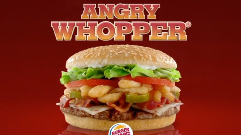 A still from an Angry Whopper commercial, showing the burger, its name, and the Burger King logo, against a red background