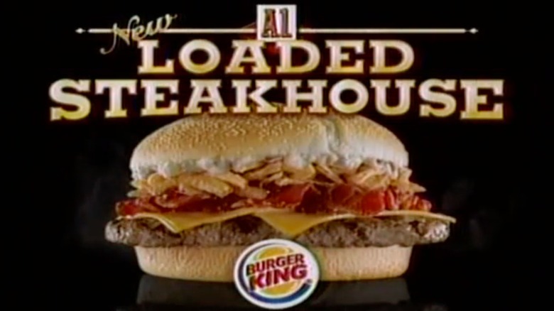 An advertisement still for a Burger King Loaded Steakhouse Burger, showing the burger, its name, and the Burger King logo