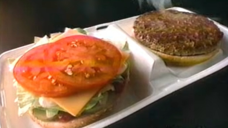 An advertisement still for a McDonald's McDLT, showing each burger bun and ingredients in their respective container sections