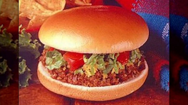 A vintage advertisement for Taco Bell's Bell Beefer burger