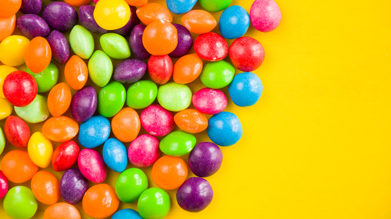 Skittles on a yellow background