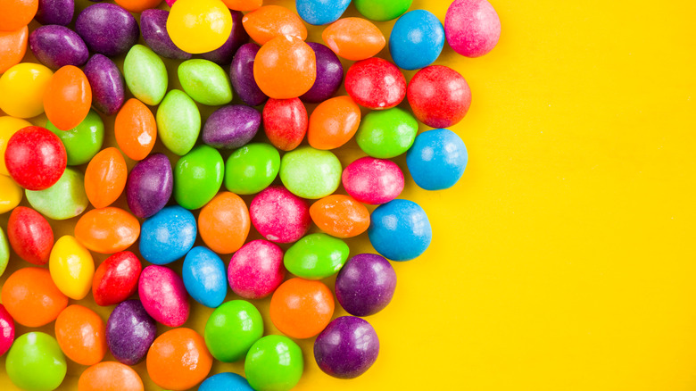 Skittles on a yellow background