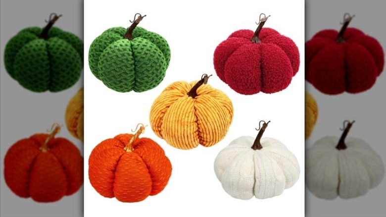 Fabric pumpkins in green, red, yellow, orange, and white on a white background