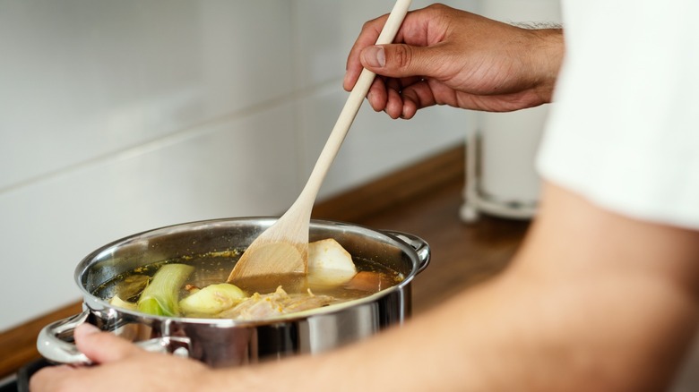 Man stirring soup