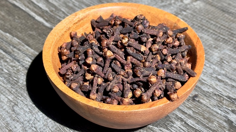 Pile of cloves in a wooden bowl