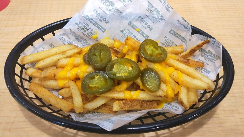 Wingstop French fries, with cheese sauce and jalapeños on top