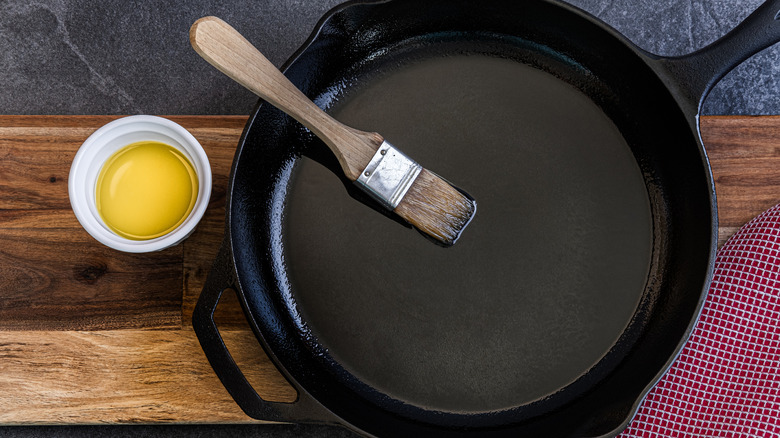 Oil and brush with cast iron skillet
