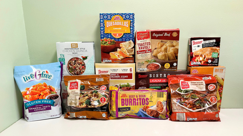 Assortment of Aldi frozen meals arranged together on a green and white background