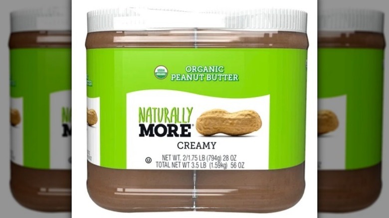 Jar of Naturally More peanut butter on white background