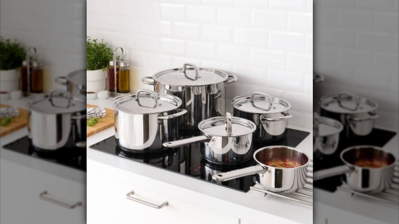 IKEA nine piece stainless steel cookware set on on stovetop and counter