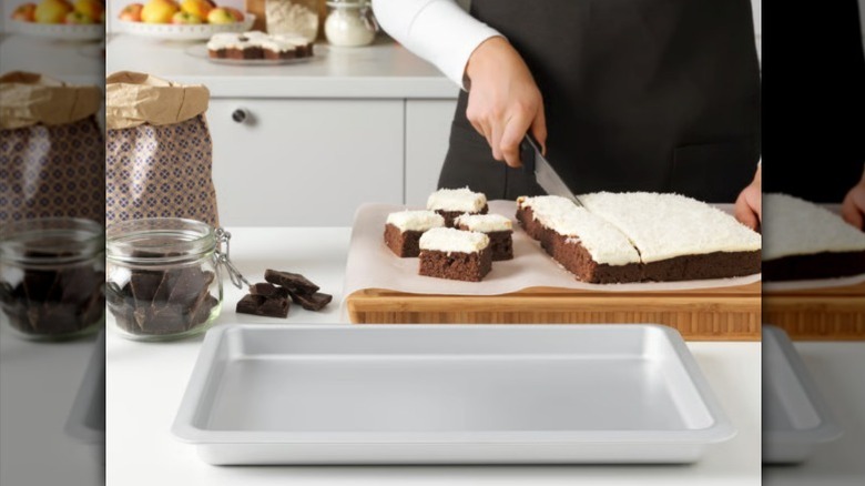VARDAGEN baking dish sitting on counter next to a hand cutting slices of a homemade cake