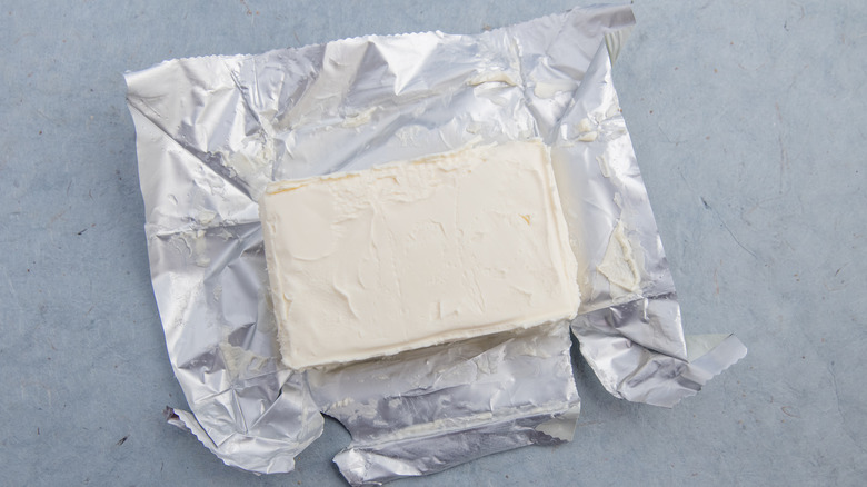 An open packet of cream cheese on a table