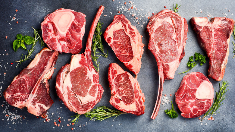 A variety of raw steaks on a table