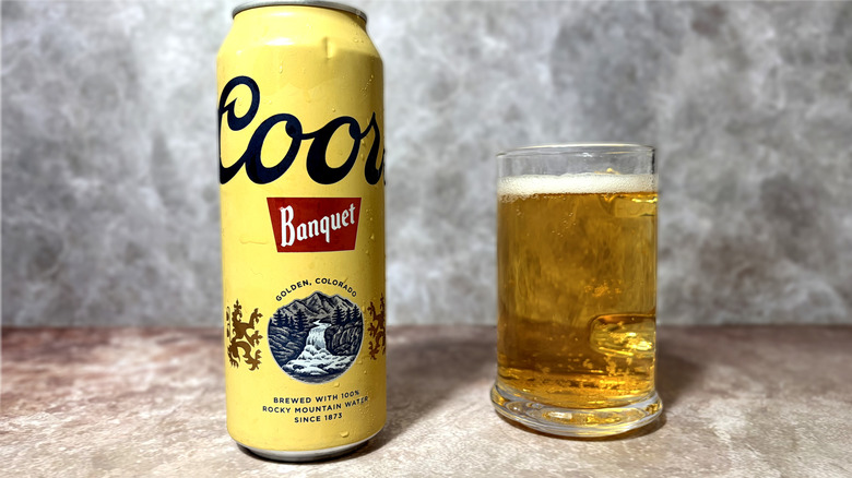 glass and can of Coors Banquet beer