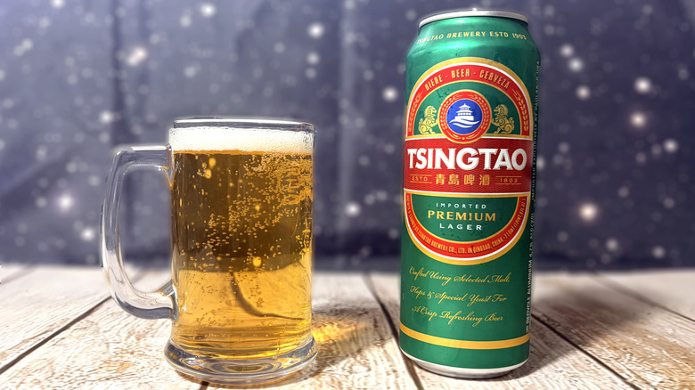 glass and can of Tsingtao beer