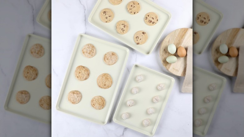Three baking sheets with cookies