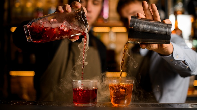 Bartenders preparing two drinks