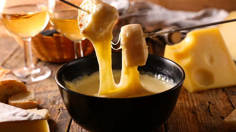 cheese fondue and wine glasses