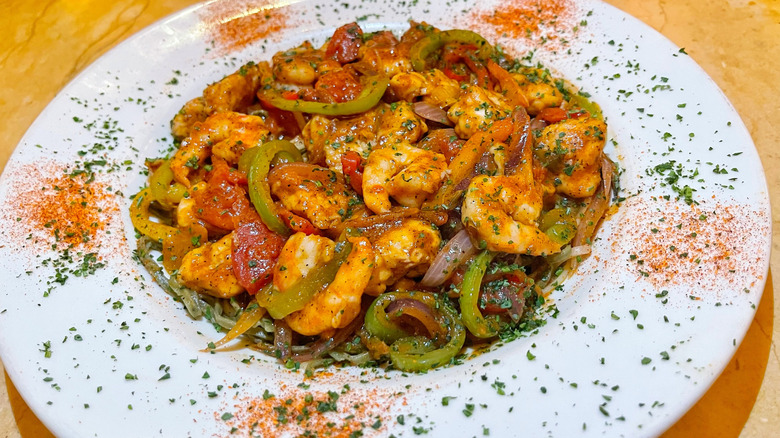 The Cajun jambalaya pasta from The Cheesecake Factory garnished with spices and parsley