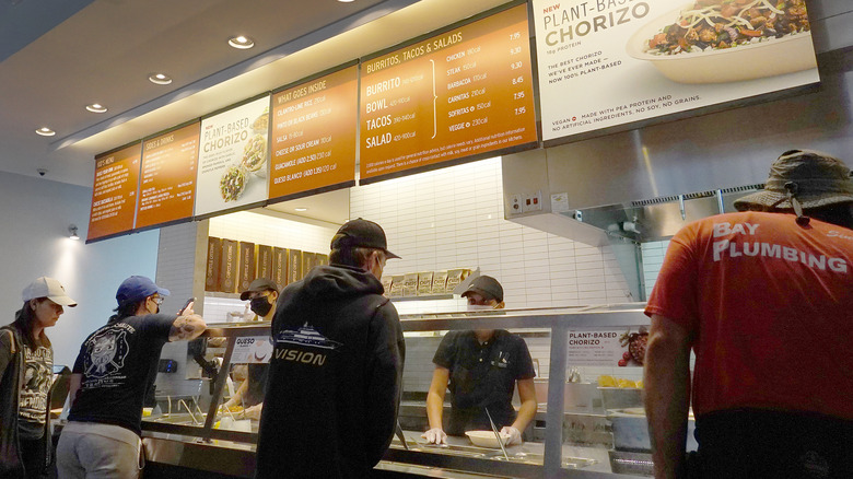 Customers are served in a Chipotle restaurant